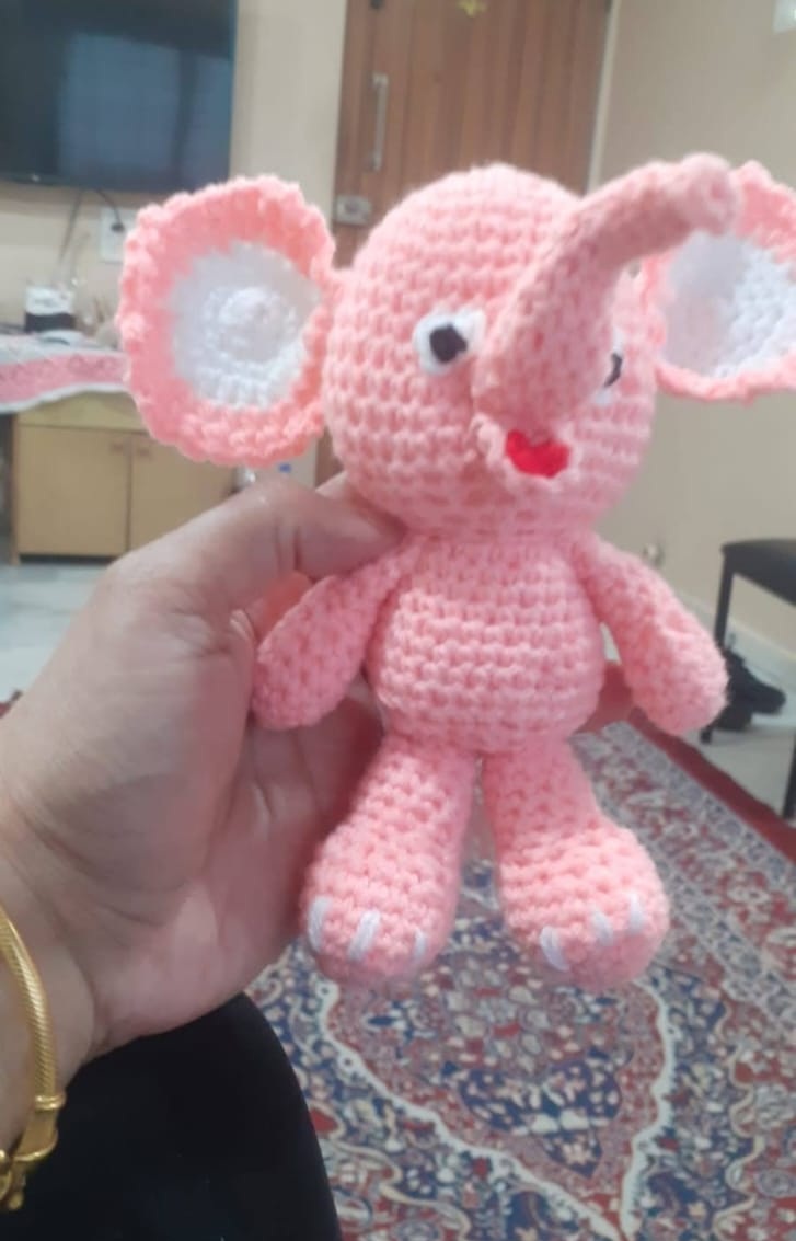 Rosie the Elephant — a soft pink crocheted elephant amigurumi with floppy ears and a gentle smile