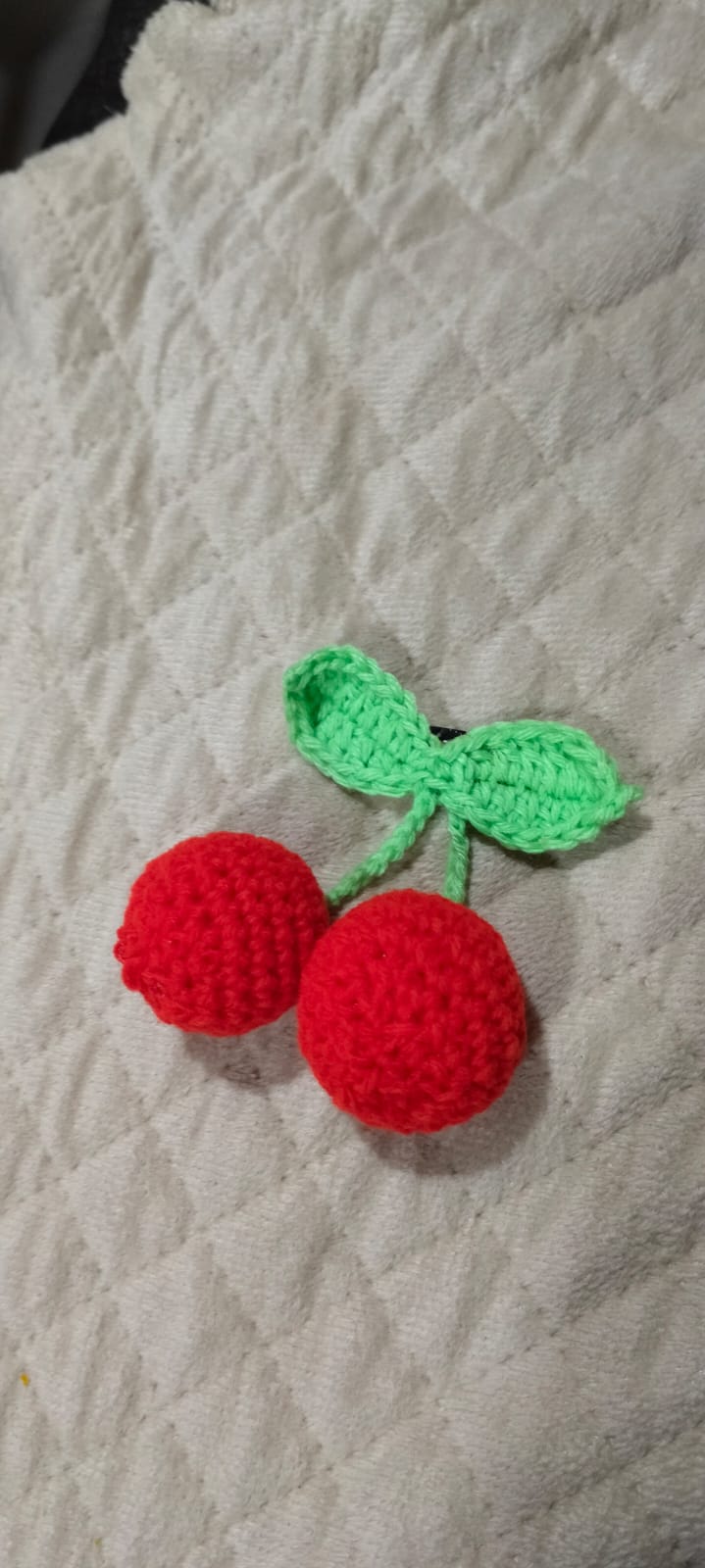 Cherry Hair Clip — a pair of bright red crocheted cherries with a green leaf, on a hair clip