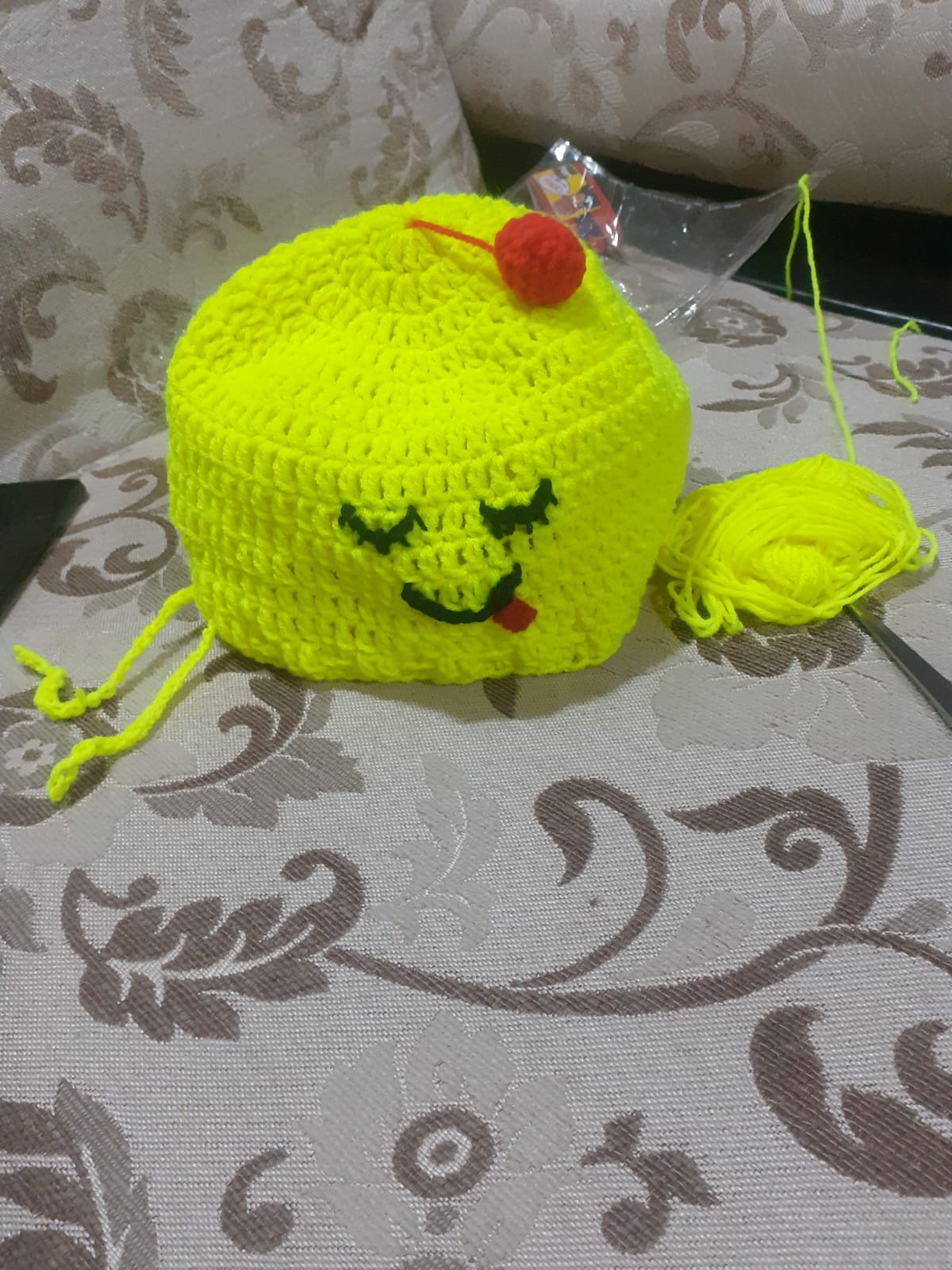 Cherry Cupcake Cap — a bright crocheted children's hat with a cherry topper